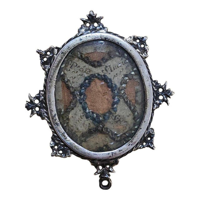 A rare and sacred 17th-century sterling silver reliquary, exquisitely crafted and preserving relics of multiple...
