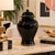 Elegant Haeger ceramic ginger jar featuring a glossy black finish accented with fine gold trim around the lid and base....