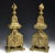 This pair of authentic antique bronze andirons showcase a Régence theme of flaming baluster vases at their top, along with...