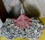 Vintage hand woven buttocks basket created by hand from twigs, including the bent handle. Dyed red reeds form the "God's...