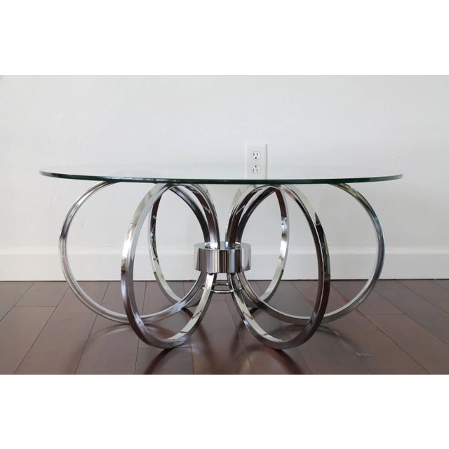 Awesome Mid-Century Milo Baughman style coffee table. Six chrome rings join together to make this unique table base....