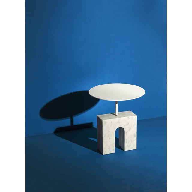 The Triumph Side Table is a sculptural table made of Carrara marble, lacquered aluminum, and brass, thoughtfully assembled...