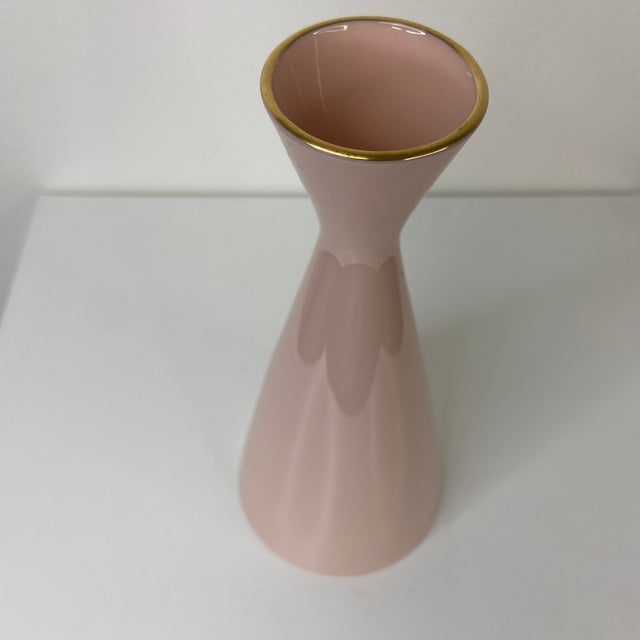 A charming mid-century Lenox porcelain bud vase in soft blush pink, featuring a flared lip and 24k gold rim. Marked with...