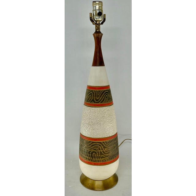 Great Midcentury ceramic lamp in orange, brown and off-white. Different texture on each bend of color. Sculpted wooden neck