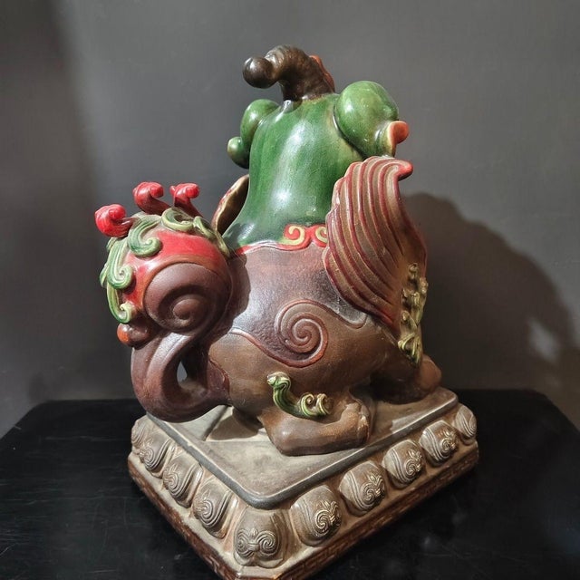 Striking matched pair of hand-sculpted Chinese Shiwan pottery Pixiu statues, finished with rich multi-color polychrome...