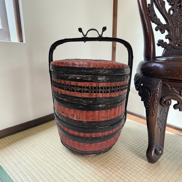 A mid-20th century Chinese wedding or dowry basket constructed of hand-split bamboo and finished in traditional red and...