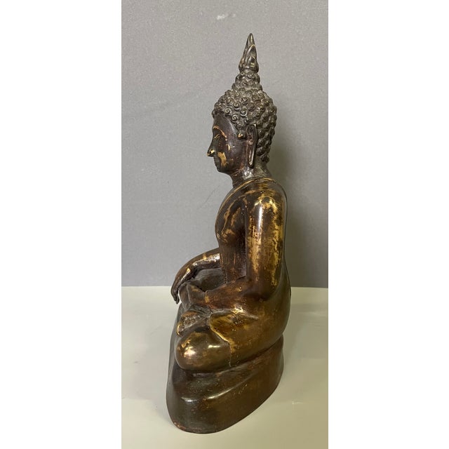 Seated bronze Buddha with two patinas, from Thailand