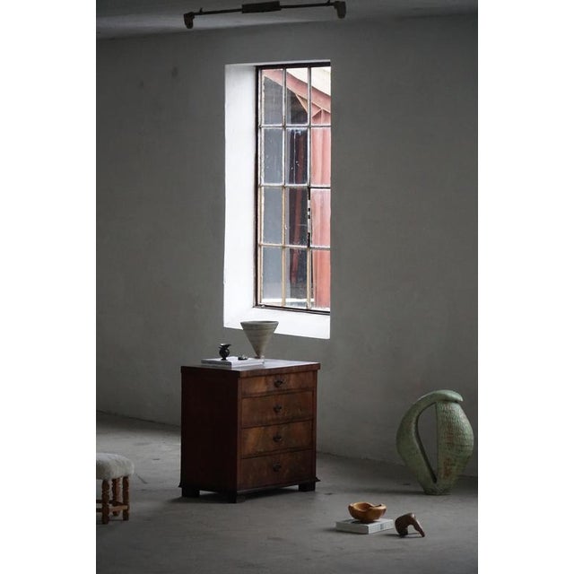 This refined late Empire chest of drawers is an elegant example of mid-19th-century furniture design, characterized by its...