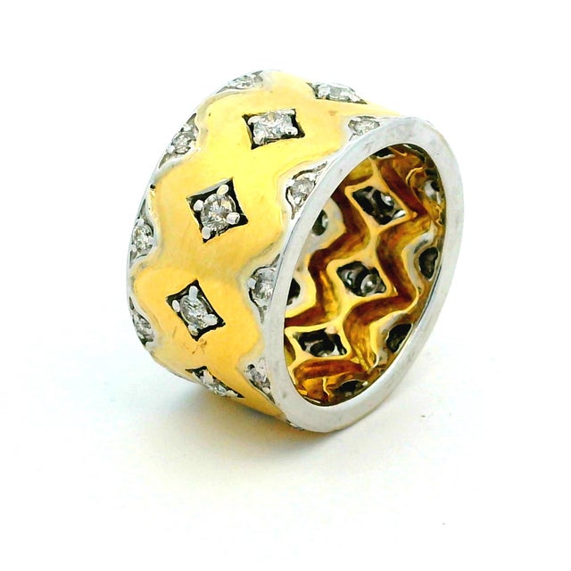 Substantial and easy to wear, this wide 18K yellow gold band is set with approximately 1 carat of diamonds throughout a...