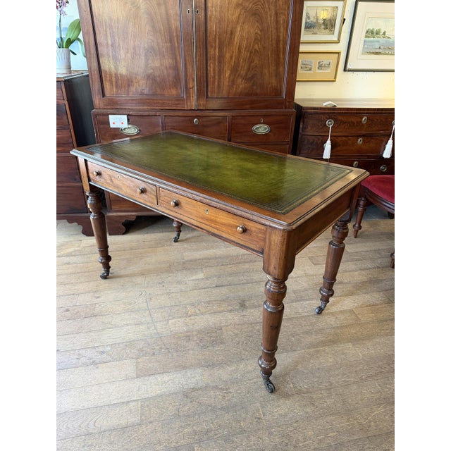 19th Century William IV Mahogany Writing Table with a green leather writing surface, two drawers, keys and small turned...