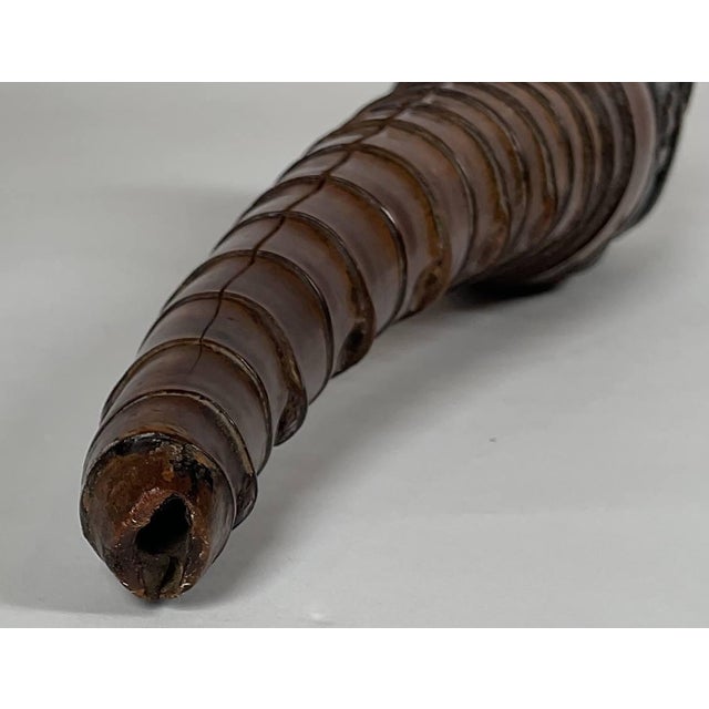 Intricately carved opium pipe from the nineteenth century. Womans head is neatly carved showing arms, hands, hat, etc.....