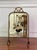Art Deco period petite brass fireplace screen with a beveled mirror and hand-painted flowers, circa 1920. A charming...