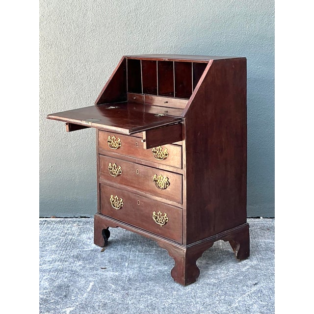 This exquisite 19th-century mahogany slant-front secretary desk exemplifies the timeless elegance of George III-era...