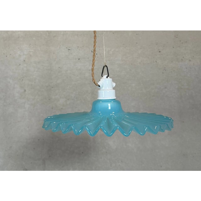 Striking collar lamp in turquoise blue glass. Original porcelain fitting and ceiling rose. Renewed cabling. E27 socket....