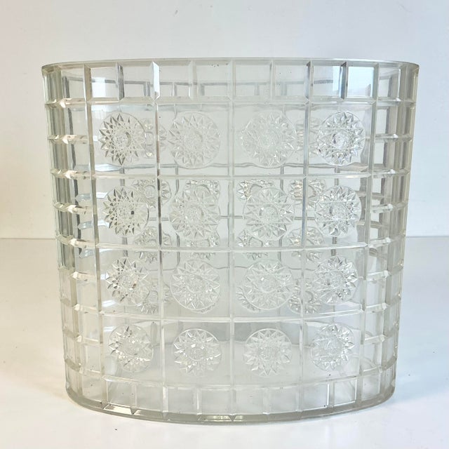 This vintage wastebasket is from the 1950s. It’s acrylic/lucite and features starburst and a grid pattern. The wastebasket...