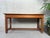 Old low table/bench in pitch pine. Equipped with 1 drawer on each short side. Comes from a school. Possibly a nursery...