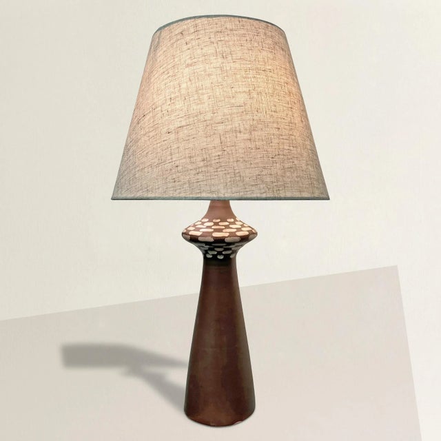 This mid-20th century American ceramic table lamp embodies the perfect blend of vintage charm and modern functionality....