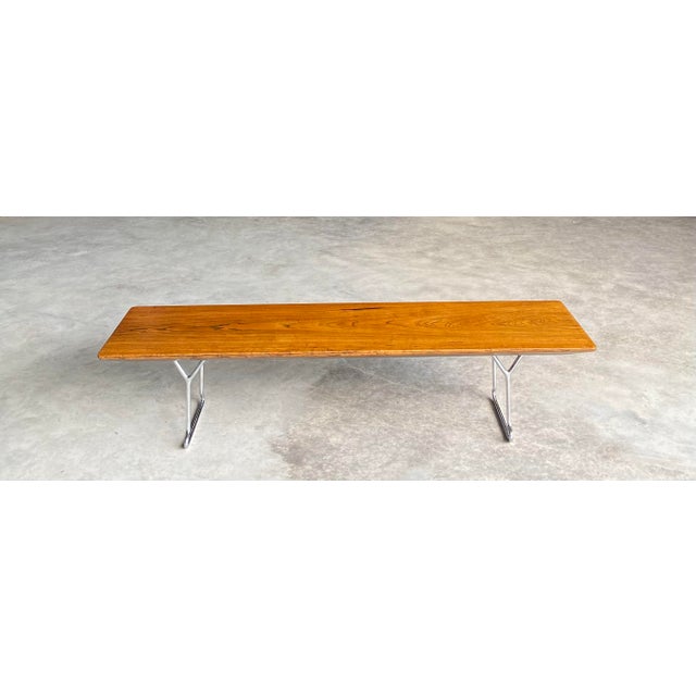 Solid ash plank bench with "knife edge" to all four sides, raised on custom heavyweight chrome legs in the style of Harry...