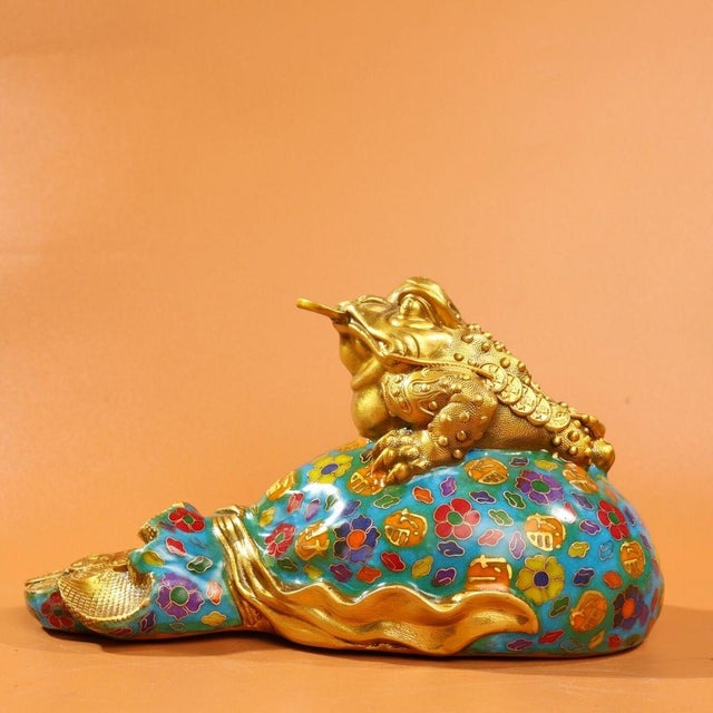 This charming vintage cloisonne enamel sculpture depicts a golden toad, or Jin Chan, perched atop a treasure bag, a...