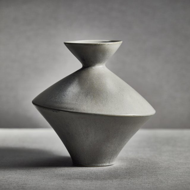 Modern, contemporary, unglazed ceramic in an exaggerated hour glass shape. Abstract but minimalist with its stoneware...