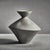 Modern, contemporary, unglazed ceramic in an exaggerated hour glass shape. Abstract but minimalist with its stoneware...