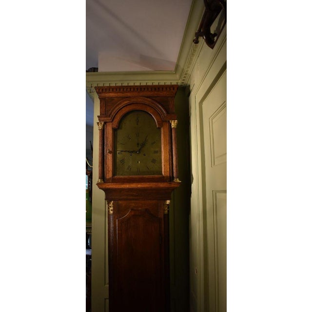 George III Oak tall clock of the late 1700s in a dark oak case by William Smith, London. Stately but not intimidating, the...