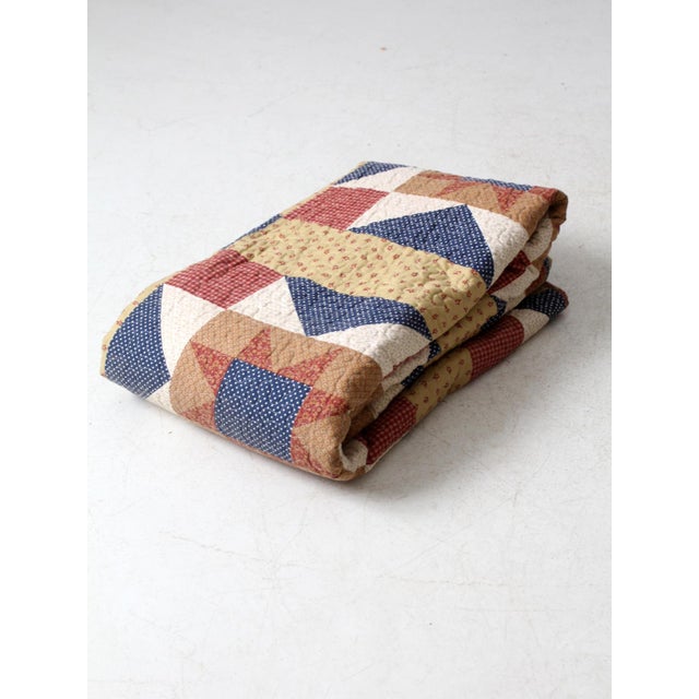 This vintage full-size quilt features a striking Americana pattern with star-spangled blocks in deep navy, brick red, and...
