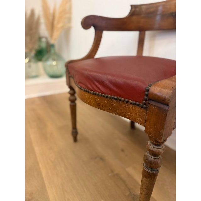 This elegant French desk chair, known as a "Fauteuil de Cabinet," features a curved backrest and a comfortable wide seat...