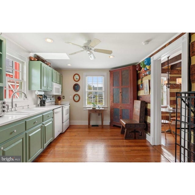 A monumental and deeply evocative antique American primitive corner cupboard, boasting an incredible, untouched painted...