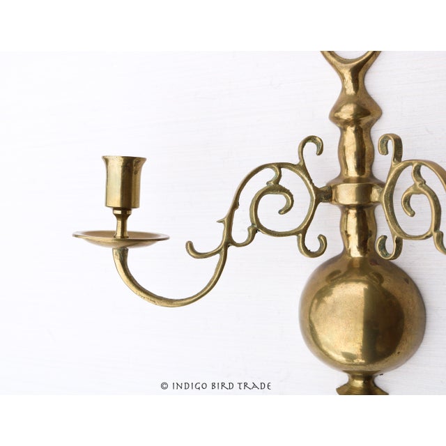 Vintage Solid Brass Ornate Sconce This stunning sconce is made from solid brass and features two ornate arms, that hold a...
