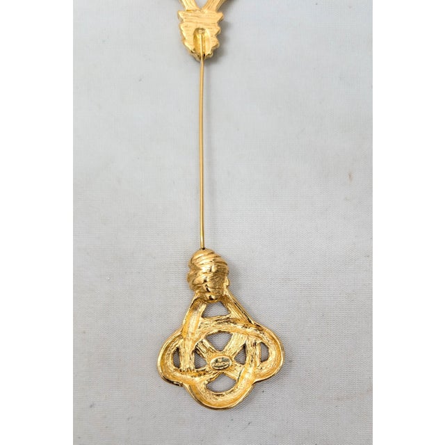 1980s goldtone "knotted" top and bottom jabot brooch Marked "© GIVENCHY PARIS NEW YORK" on a cartouche on the bottom part...