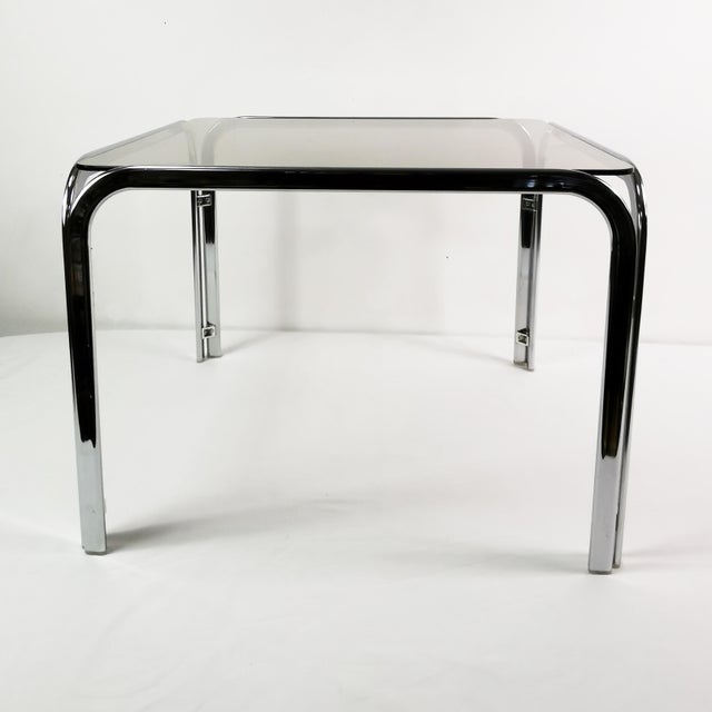 Coffee table from Germany, 1970s. It features a minimalist, modern, Bauhaus design. Made of metal with a tinted glass top....