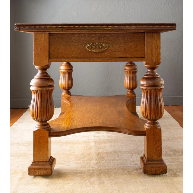 This 19th-century tiger oak library table features solid quarter-sawn oak with fine bead moulding around the table edge...