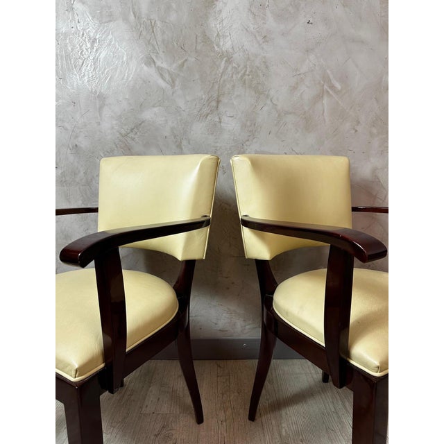 An elegant pair of Art Deco bridge chairs, circa 1930, crafted from stained solid mahogany and upholstered in cream-beige...