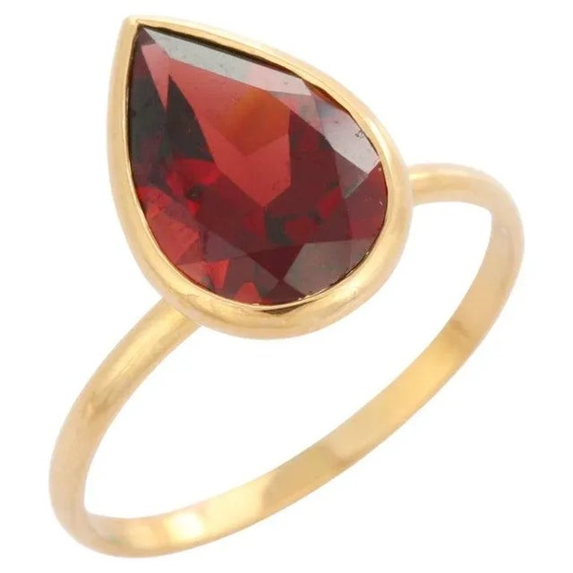 Garnet Cocktail Ring in 18K Gold is a perfect statement jewelry to match with every outfit of your wardrobe. It's just a...