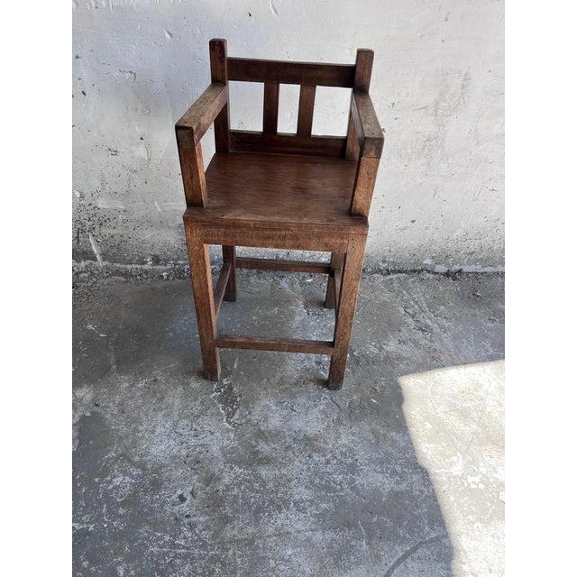 A striking Brutalist children’s chair crafted from solid oak, distinguished by its bold architectural lines and robust...