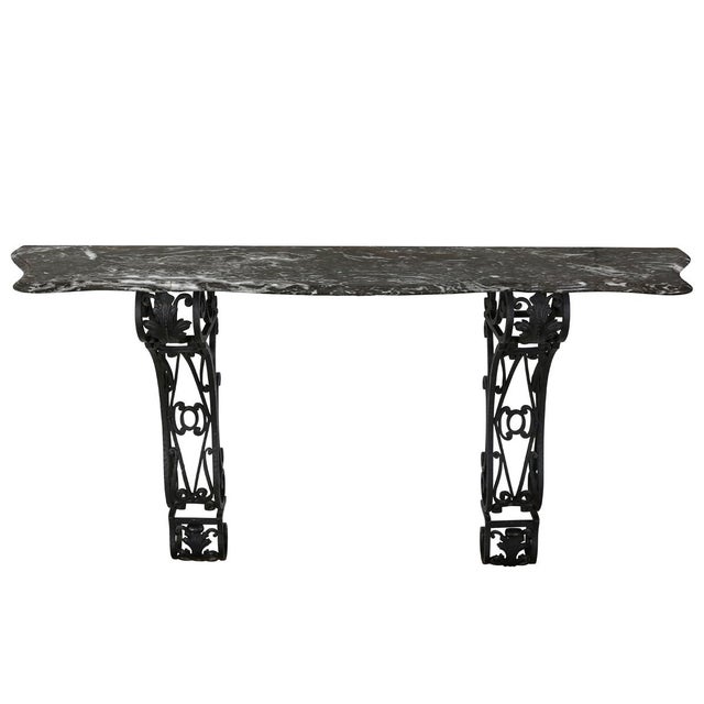 This console table embodies European classical elegance &nbsp;with a touch of French rococo influence. The black marble...