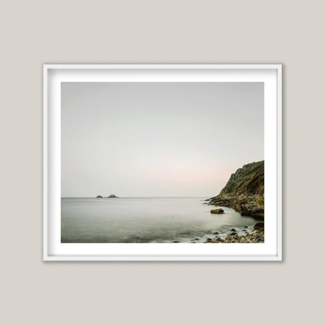 An early morning photograph captures the serene beauty of Porth Nanven (Cot Valley) in Cornwall, England. The rugged,...