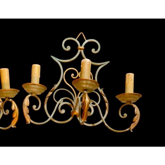 This piece is firmly rooted in the early 20th-century French wrought iron aesthetic, but more "neo-rustic/revival" than...