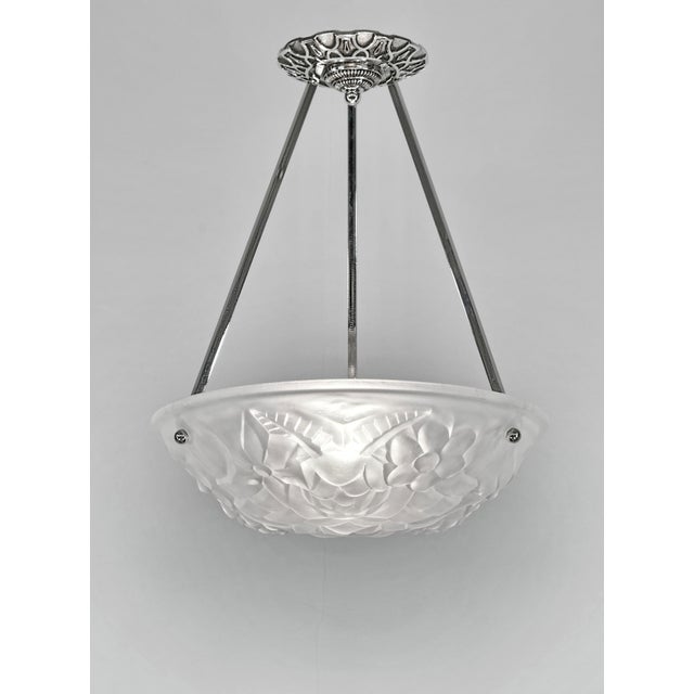 Degué A French art deco pendant light made circa 1930 in nickel plated bronze or solid brass holding a bowl by Degué in a...