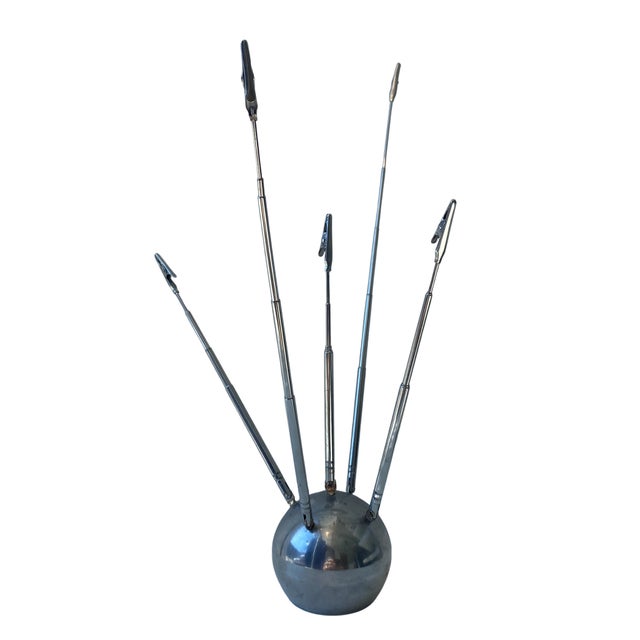 This sculptural telescopic chrome memo holder captures the playful futurism and atomic-age sensibility that defined mid-...
