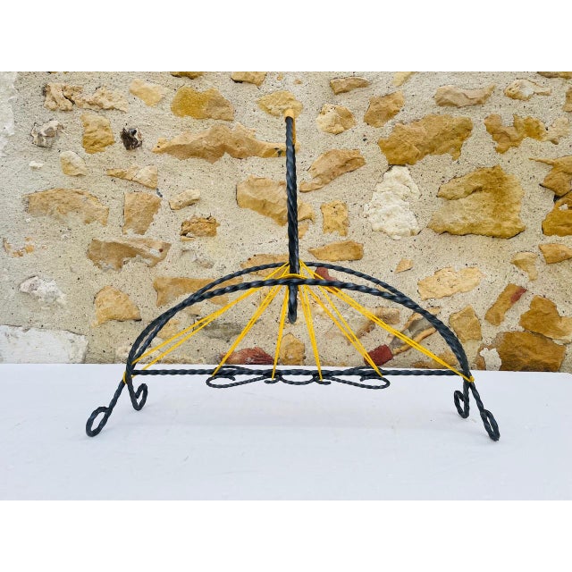 Vintage, mid-century, magazine rack made of wrought iron and scoubidou, from the 1950's. the rack features a very cool,...