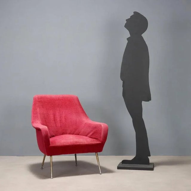 Vintage armchair of Italian manufacture with original period fabric upholstery in shades of red and brass legs. This piece...