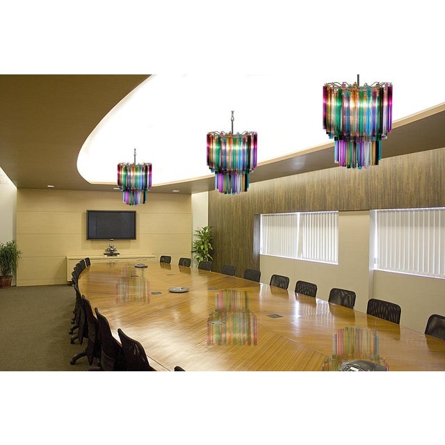 Fantastic pair of Murano chandeliers each made by 107 Murano crystal multicolored prism in a nickel metal frame. The...