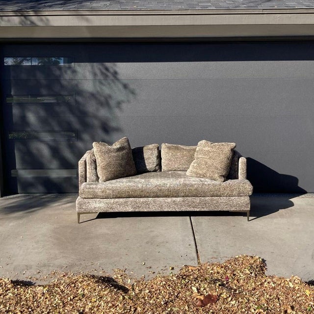 This Theodore Alexander 3-seat sofa features a modern design with plush cushions and soft fabric. The neutral color easily...