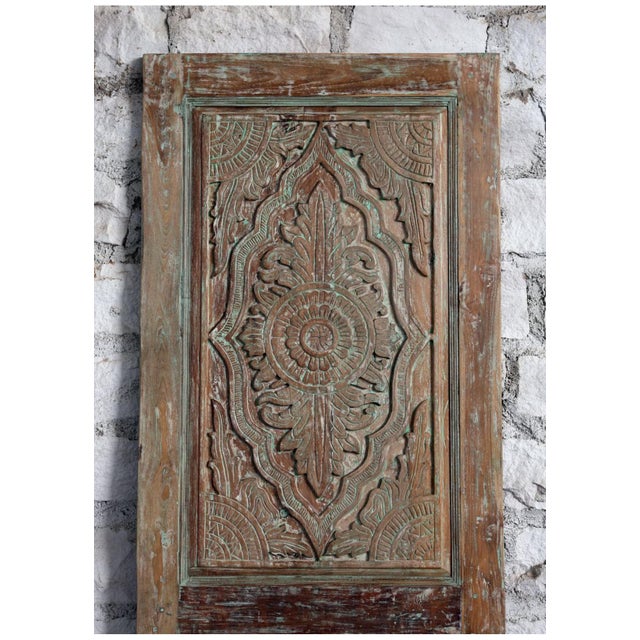 A striking antique carved door adorned with delicate floral motifs and layered green hues, this one-of-a-kind piece brings...