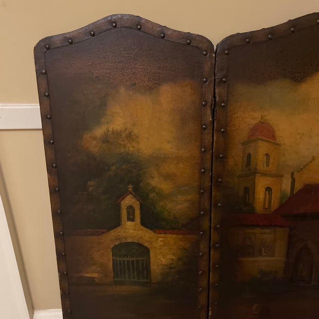 Antique trifold triptych hand painted leather screen depicting a village church or abbey. Can be hung on a wall or used as...