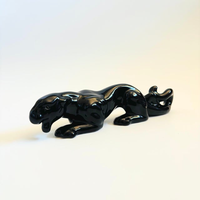 A mid century black panther sculpture. Made of ceramic and finished in a glossy black glaze. A great sculptural statement...