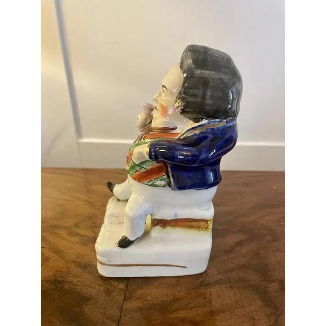 Antique Victorian Staffordshire flatback figure of a seated man in period costume holding a drink H 14.5cm x W 7cm x D 8cm...
