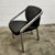 Armchairs with a chromed steel frame and black faux leather upholstery. This mid-century modern piece was manufactured in...